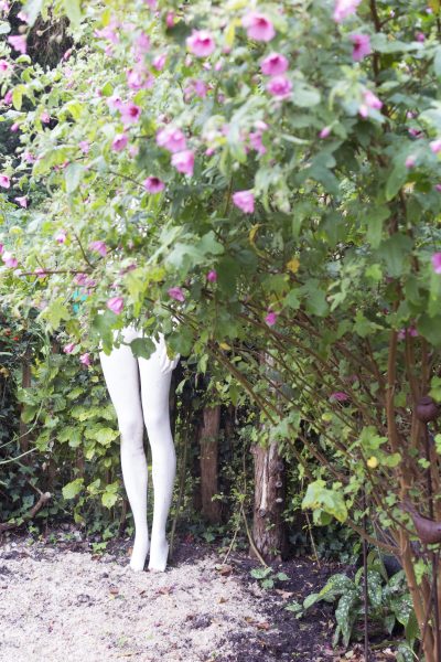 A shop mannequin used as garden statuary