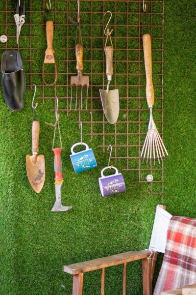 Garden tools hanging on a grid keep your shed tidy