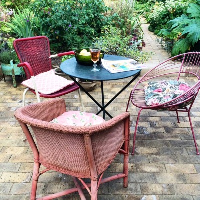 Buy odd chairs with a theme, such as these retro pink and red chairs.