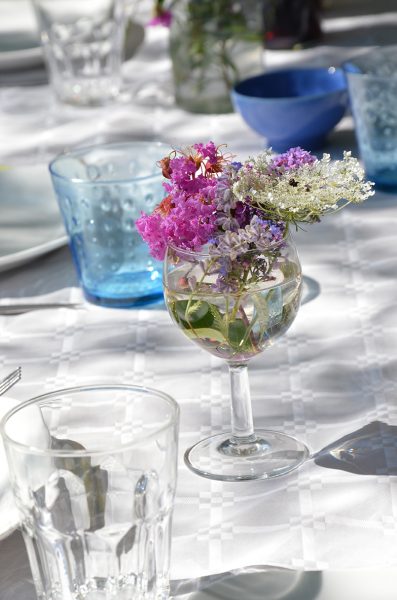 Use wine glasses for flowers.